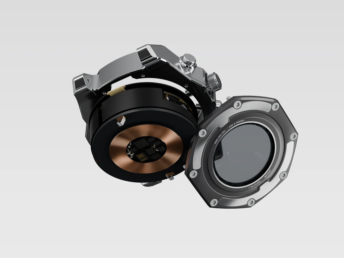 Render of the Tech Puck coming out of the back of the watch, the charging coil facing the camera and the caseback with its eight screws set aside.